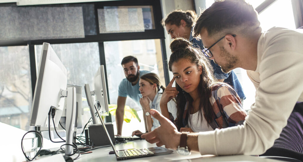 A diverse team of professionals collaborating in the SpinaFX office.